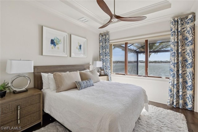 bedroom featuring visible vents, ceiling fan, ornamental molding, wood finished floors, and a water view