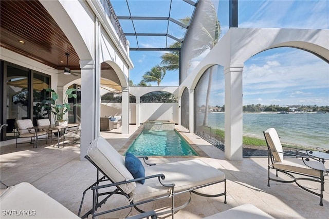 view of pool featuring a pool with connected hot tub, a water view, a patio area, ceiling fan, and fence