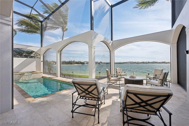 view of swimming pool with a water view, a patio area, a pool with connected hot tub, and a lanai