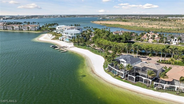 drone / aerial view featuring a water view and a beach view