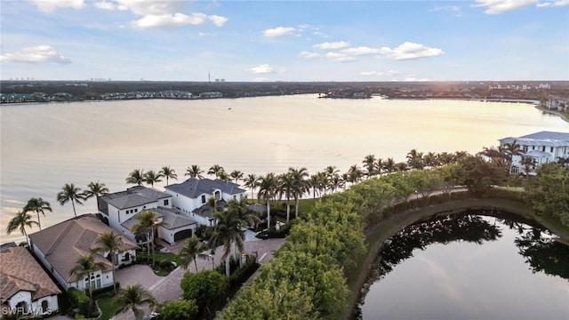 drone / aerial view featuring a residential view and a water view