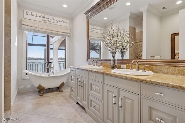 bathroom with ornamental molding, a water view, and a sink