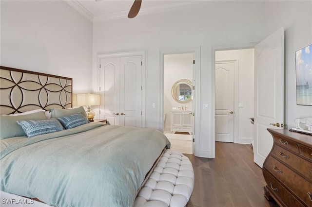 bedroom featuring ceiling fan, connected bathroom, wood finished floors, a closet, and crown molding