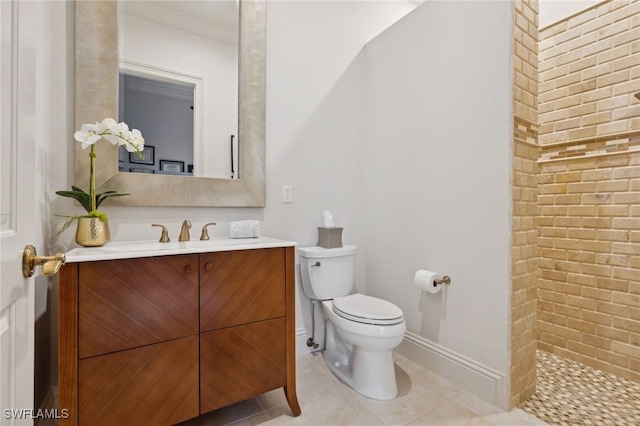 full bath with tile patterned floors, toilet, vanity, baseboards, and walk in shower