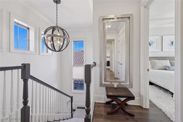 hallway with ornamental molding, dark wood-style flooring, baseboards, and an upstairs landing