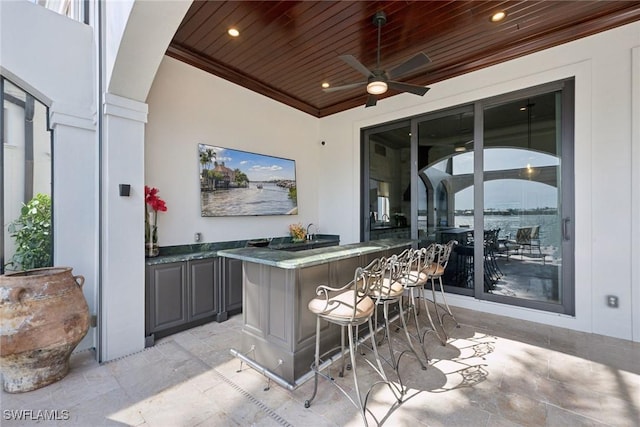 view of patio featuring ceiling fan and outdoor wet bar