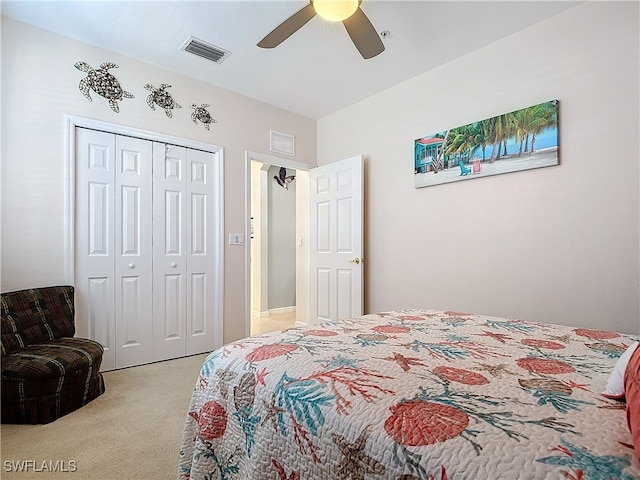 bedroom featuring visible vents, light colored carpet, a closet, and a ceiling fan