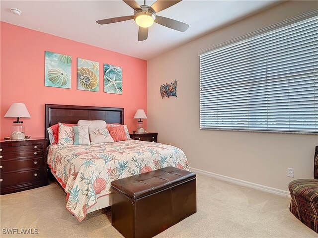 carpeted bedroom featuring a ceiling fan and baseboards