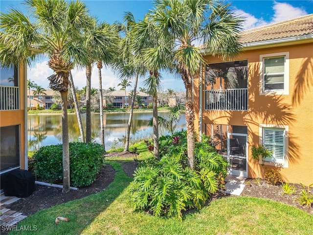 view of yard with a balcony and a water view