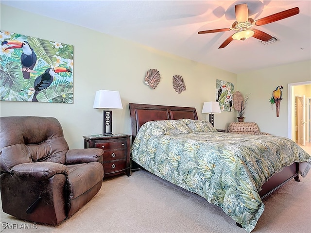 bedroom featuring visible vents, light carpet, and ceiling fan