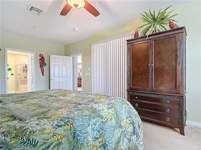 bedroom with visible vents, light colored carpet, ensuite bath, and ceiling fan