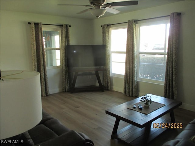 living area featuring ceiling fan, wood finished floors, and baseboards