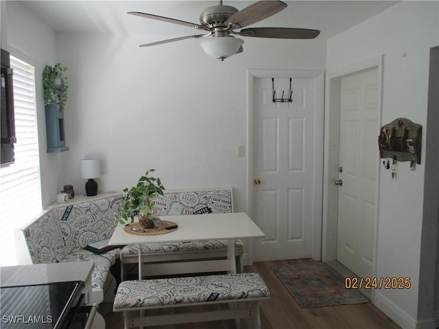 dining room with a ceiling fan, breakfast area, and wood finished floors