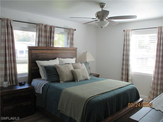 bedroom with multiple windows and ceiling fan