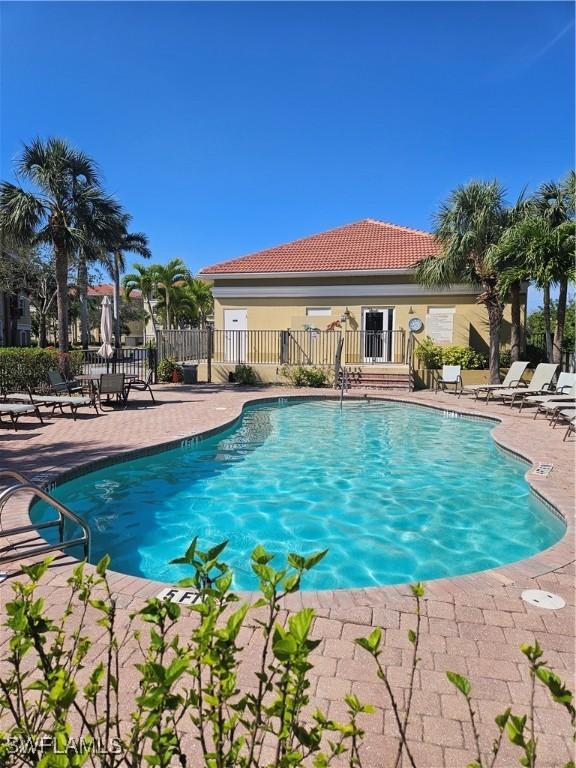 pool with fence and a patio