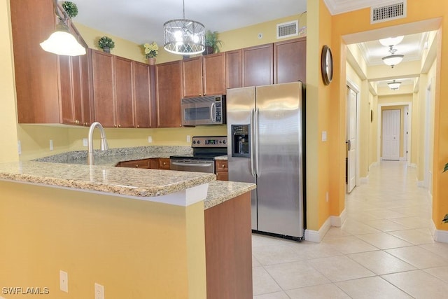 kitchen with stainless steel appliances, visible vents, a peninsula, and light tile patterned floors