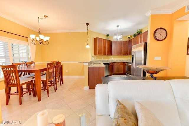 kitchen featuring appliances with stainless steel finishes, hanging light fixtures, crown molding, and a peninsula