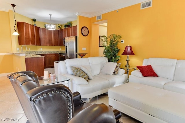 living area with ornamental molding, visible vents, and light tile patterned floors