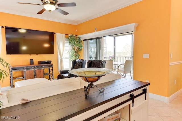 living room with ornamental molding, a ceiling fan, baseboards, and light tile patterned floors