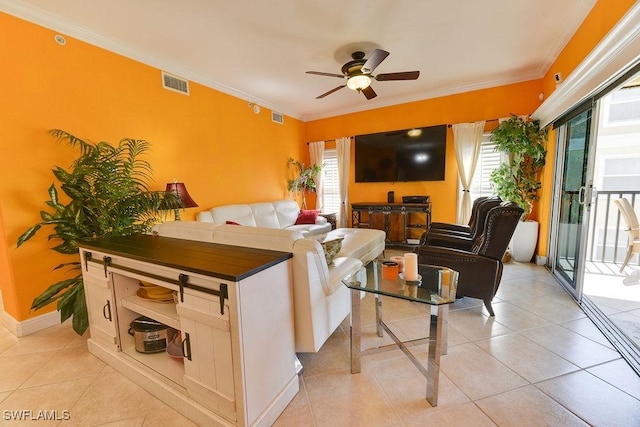 living area featuring light tile patterned floors, visible vents, and crown molding