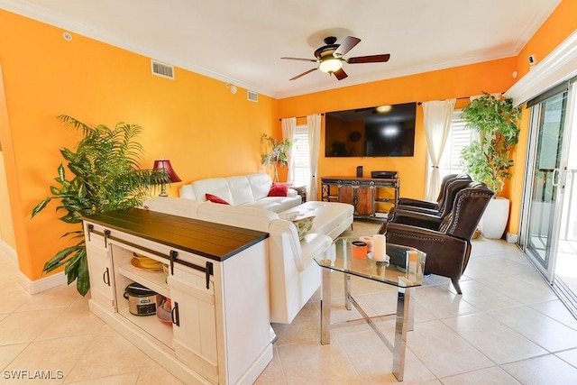 living area with light tile patterned floors, ceiling fan, visible vents, and crown molding