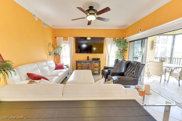 living area featuring a ceiling fan, plenty of natural light, visible vents, and crown molding