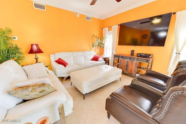 living area featuring light tile patterned floors, a ceiling fan, visible vents, and crown molding