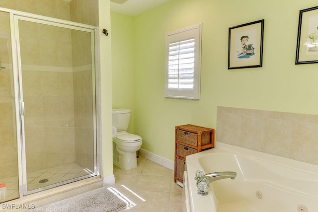 bathroom with a stall shower, baseboards, toilet, a tub with jets, and tile patterned floors