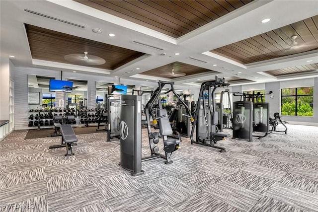 exercise room featuring carpet floors, wooden ceiling, a tray ceiling, and recessed lighting