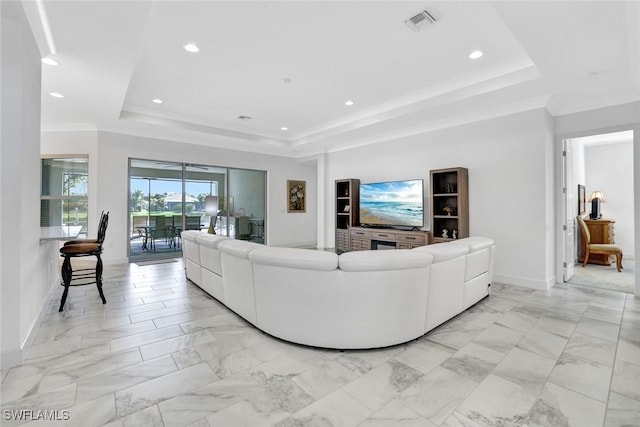 living room featuring marble finish floor, a tray ceiling, and recessed lighting