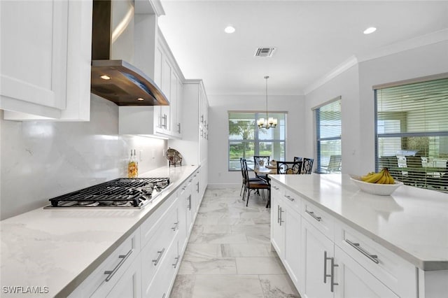 kitchen featuring marble finish floor, stainless steel gas cooktop, visible vents, ornamental molding, and wall chimney range hood