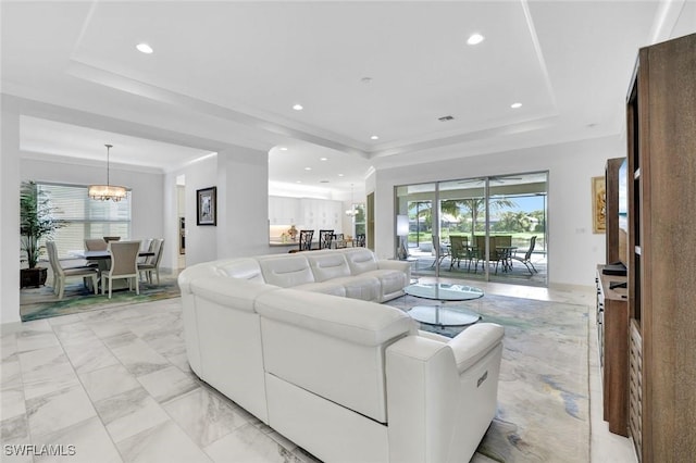 living area with marble finish floor, a raised ceiling, and recessed lighting