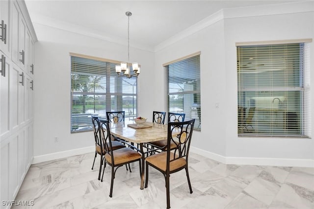 dining room featuring crown molding, plenty of natural light, a notable chandelier, and baseboards