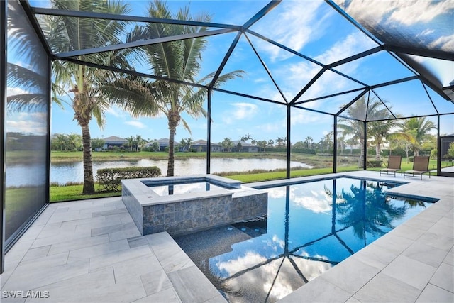 view of pool featuring a patio, a pool with connected hot tub, a water view, and glass enclosure