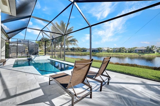 view of swimming pool with glass enclosure, a patio area, and a water view