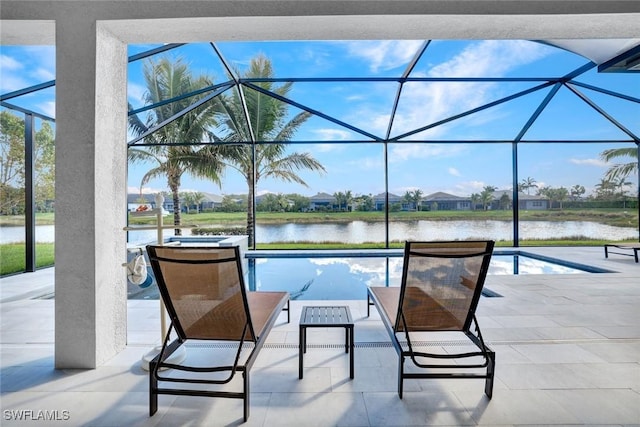 pool featuring a lanai, a water view, and a patio