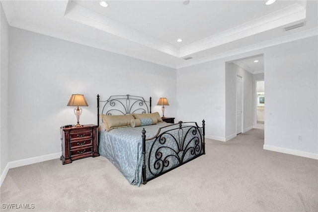 carpeted bedroom featuring baseboards, visible vents, ornamental molding, and a raised ceiling