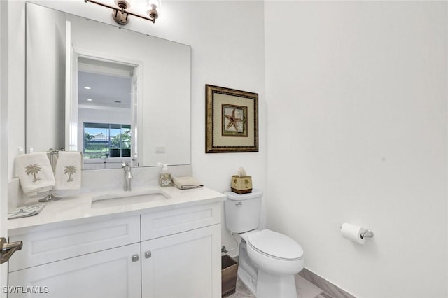 bathroom with toilet and vanity