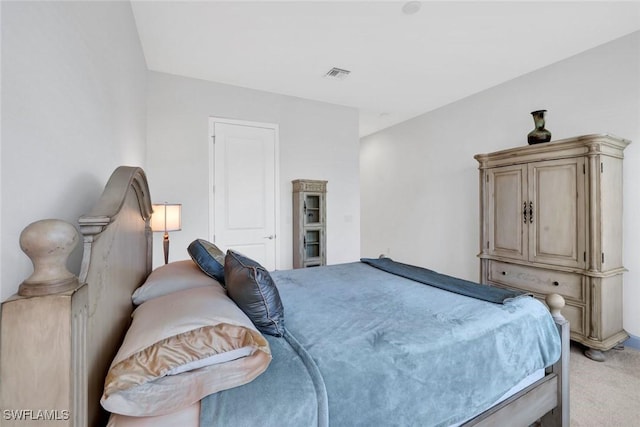 bedroom with light colored carpet and visible vents