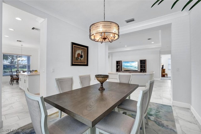 dining room with ornamental molding, visible vents, and an inviting chandelier