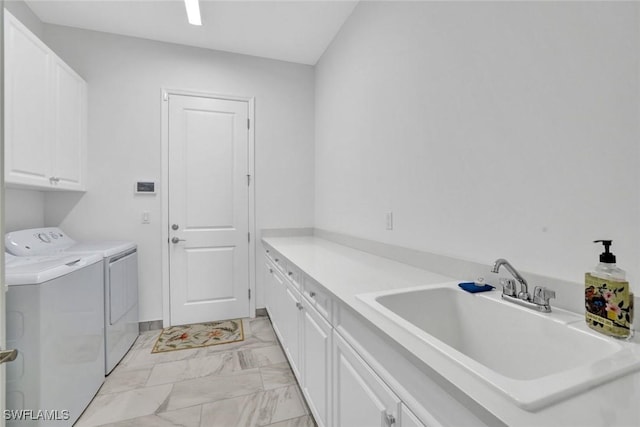 laundry room with marble finish floor, cabinet space, a sink, and washer and clothes dryer