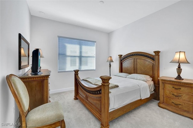 bedroom featuring light carpet and baseboards