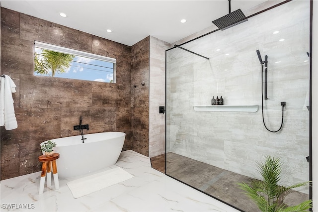 full bathroom featuring a walk in shower, marble finish floor, a freestanding tub, and recessed lighting