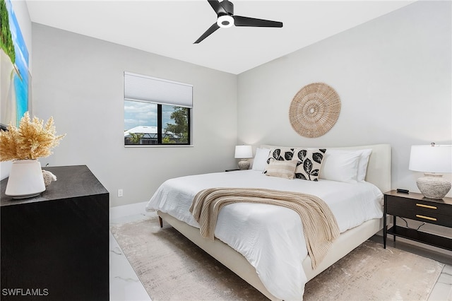 bedroom with marble finish floor, baseboards, and a ceiling fan