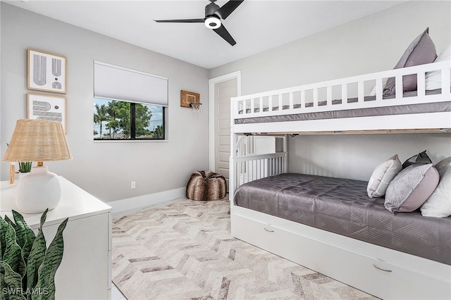 bedroom with light colored carpet, ceiling fan, and baseboards