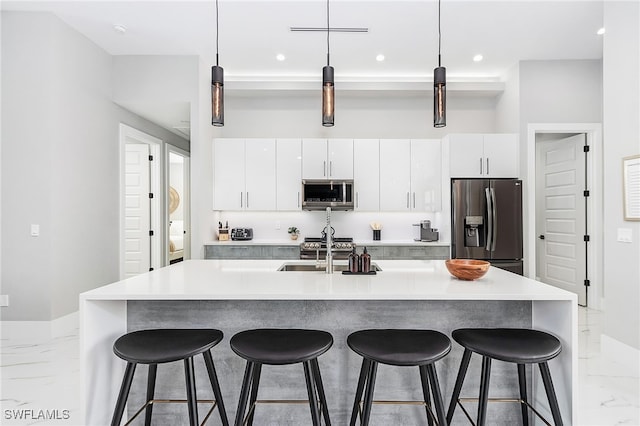 kitchen featuring stainless steel appliances, marble finish floor, light countertops, and modern cabinets