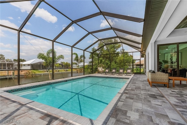 pool featuring a lanai, a patio area, and a water view