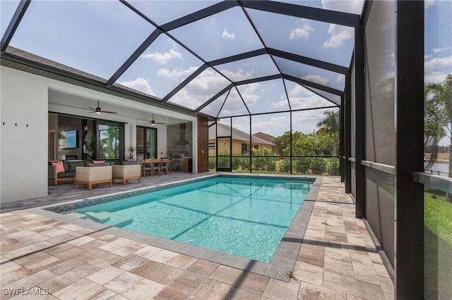 pool featuring a ceiling fan, a lanai, a patio area, and an outdoor hangout area