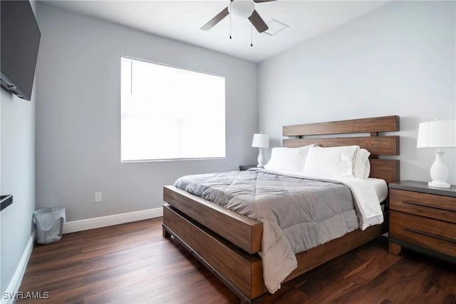 bedroom with ceiling fan, dark wood-style flooring, and baseboards