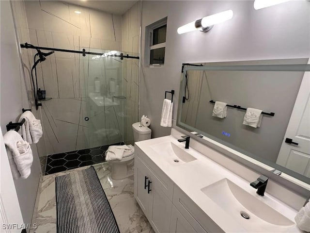 bathroom with a stall shower, marble finish floor, a sink, and toilet